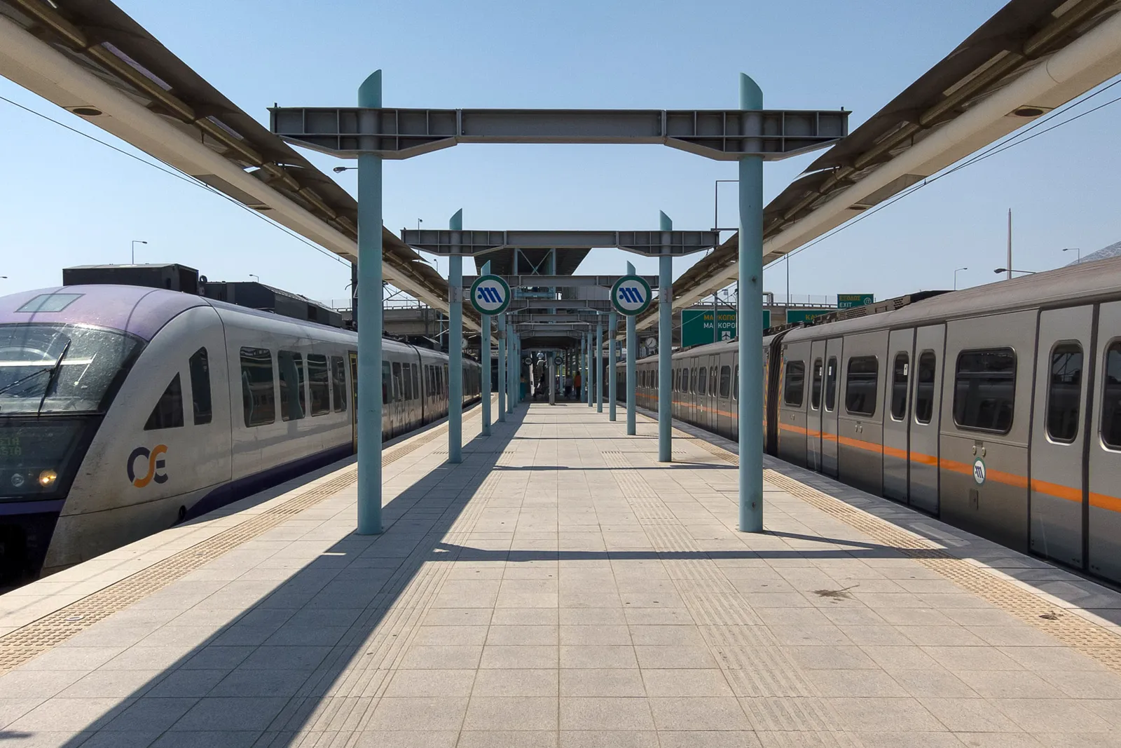 An Athens metro station platform on the airport line on a bright day