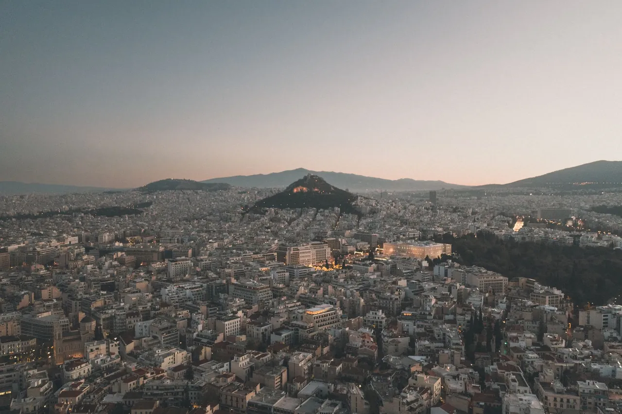 Sunset view over Athens, Greece, from the top of Lycabettus Hill with the Acropolis in the distance