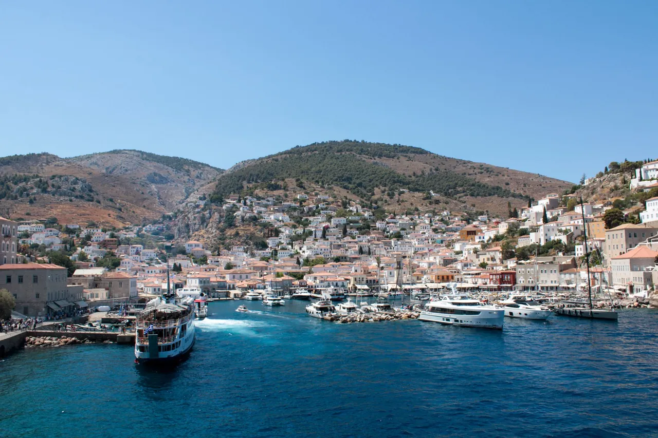 Car-free harbour of Hydra island in the Saronic Gulf, Greece, with stone houses and boats