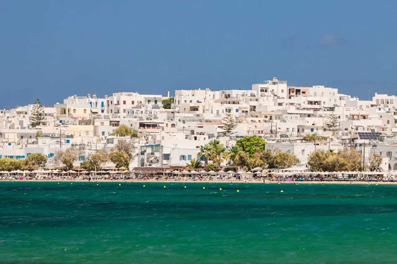 A long sandy beach with clear water on Naxos in the Cyclades, Greece
