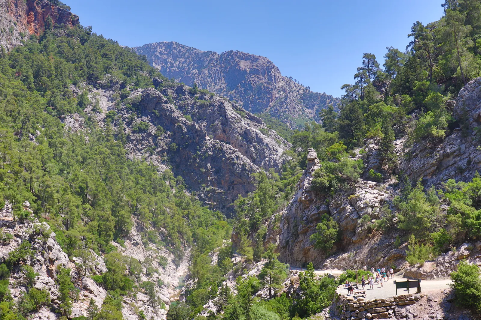Walkers on a path through a steep mountain gorge in western Crete