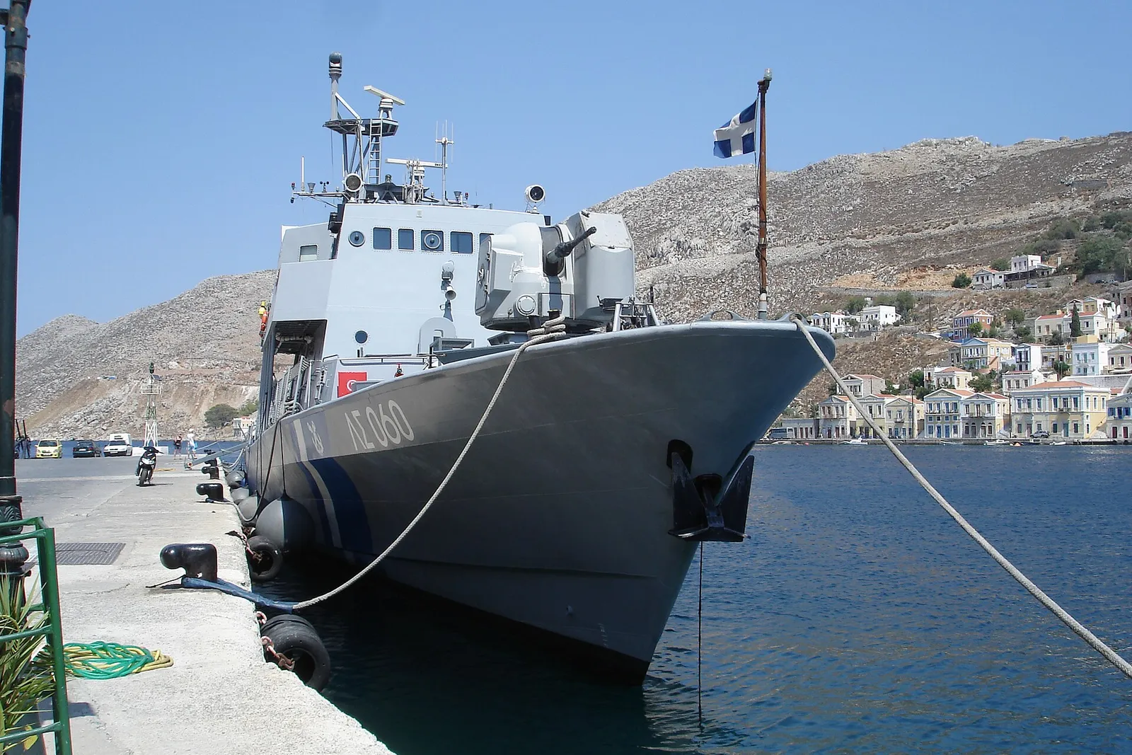 A Hellenic Coast Guard patrol vessel in a Greek harbour on a clear day