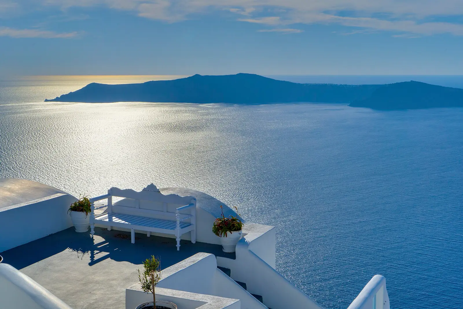 The Santorini caldera seen from a whitewashed terrace in Oia, Greece