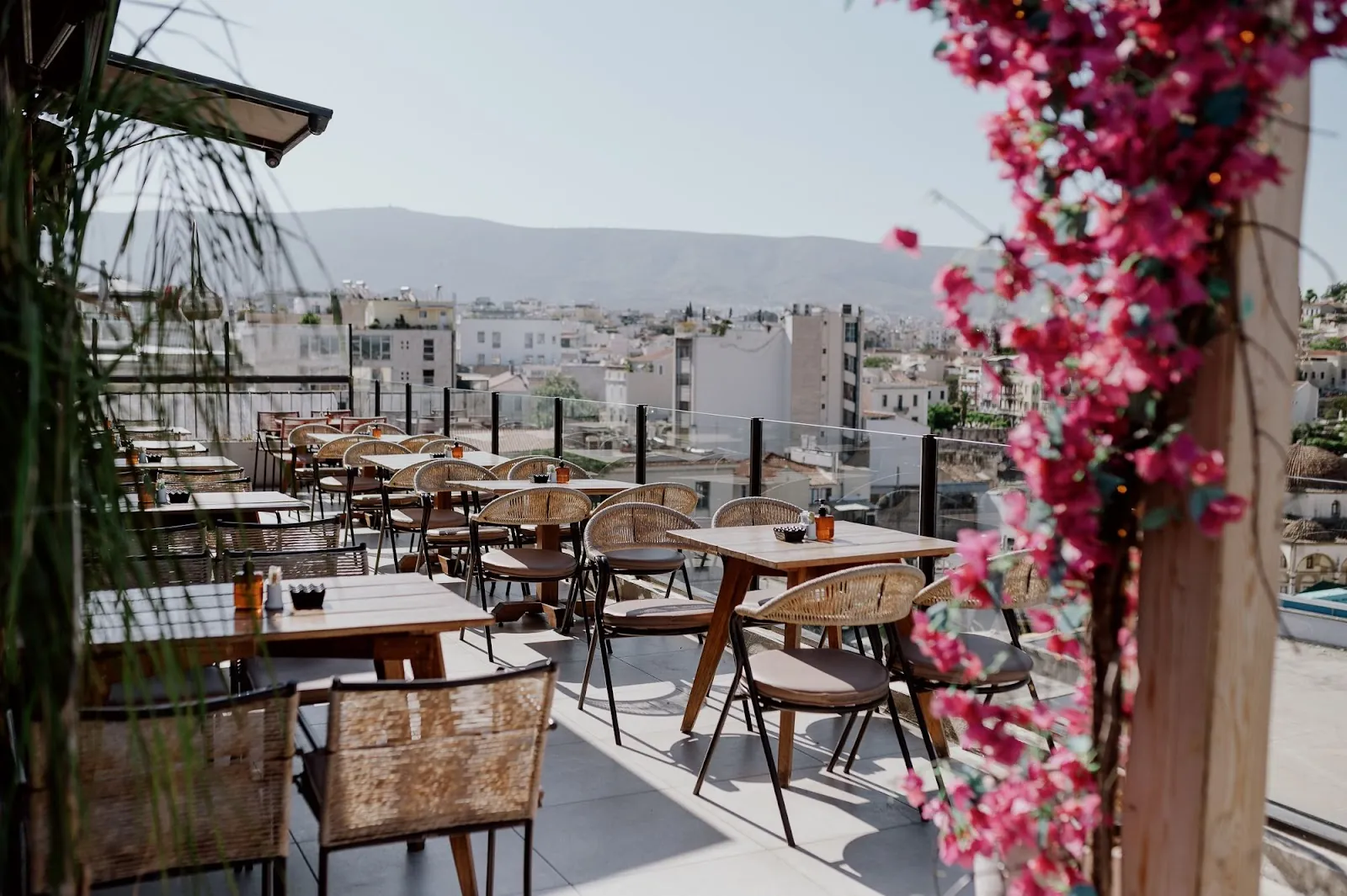 Rooftop bar in Athens Greece with the illuminated Acropolis and Parthenon in the background at night