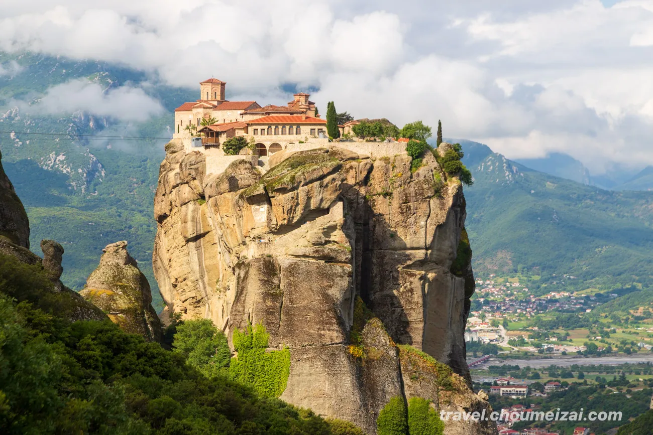 Monasteries perched on rock pillars at Meteora, Greece, glowing at sunset