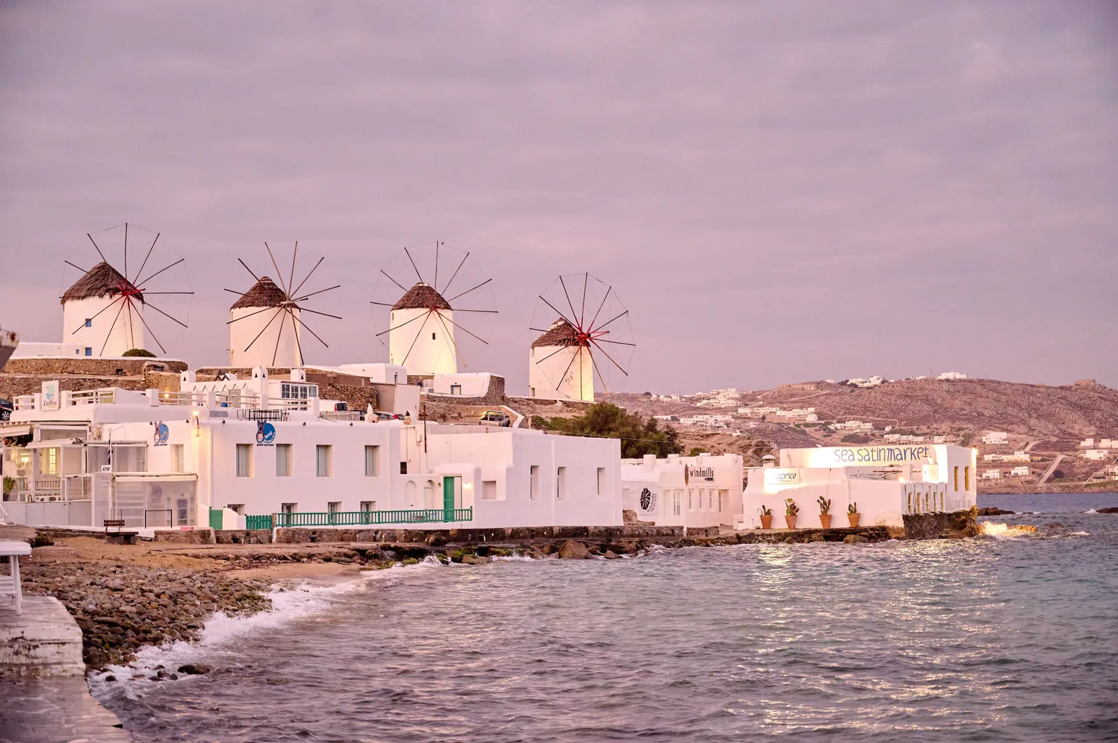 The row of whitewashed windmills on the ridge above the waterfront in Mykonos Town