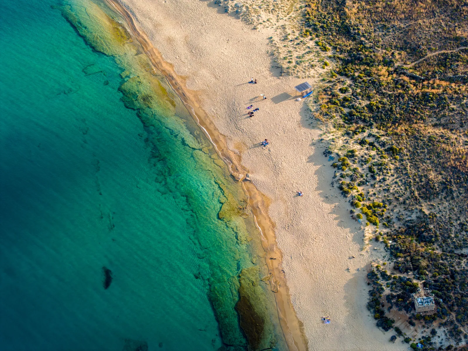 A wide empty sandy bay on the windy northern coast of Mykonos