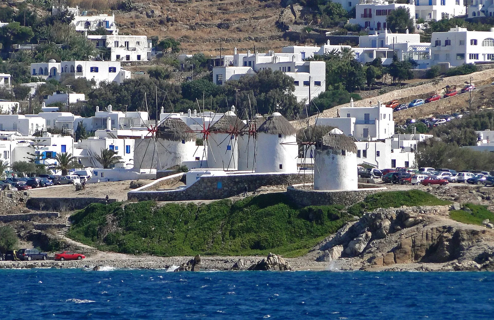 The famous row of whitewashed windmills above the sea in Mykonos Town, Greece, on a clear sunny day