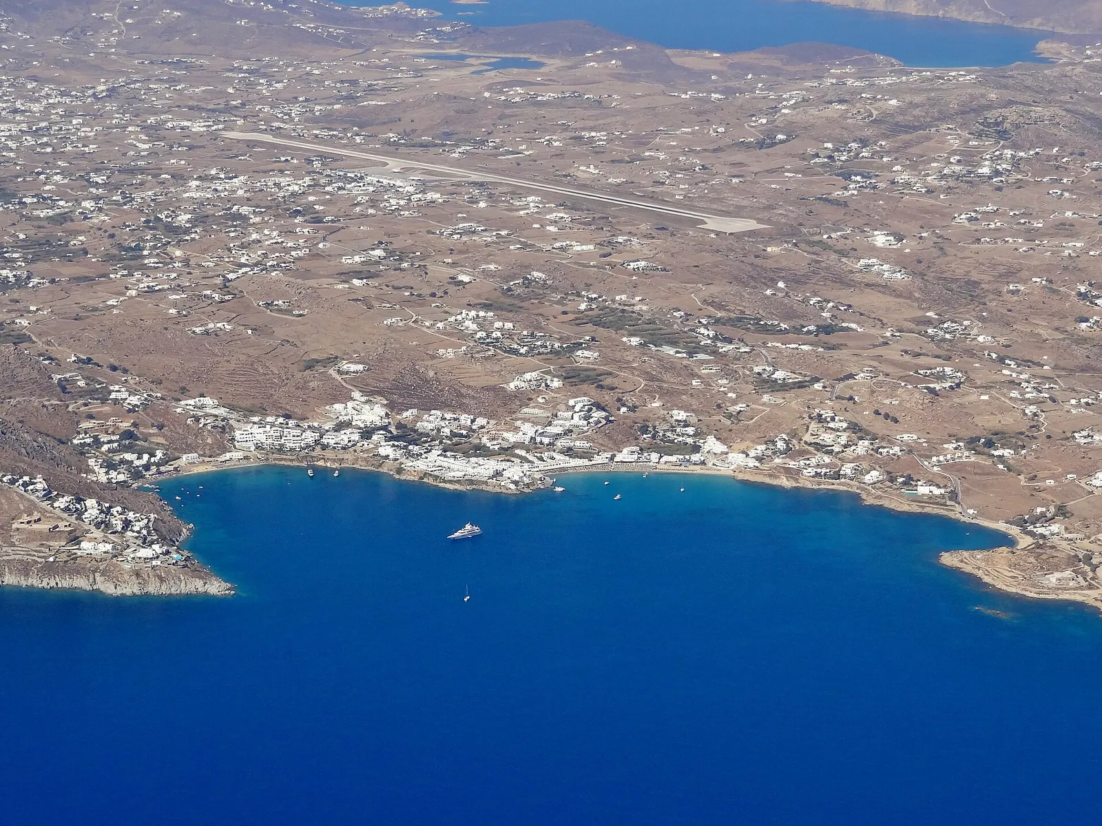 An aerial view of a bay and its settlement on Mykonos, Greece