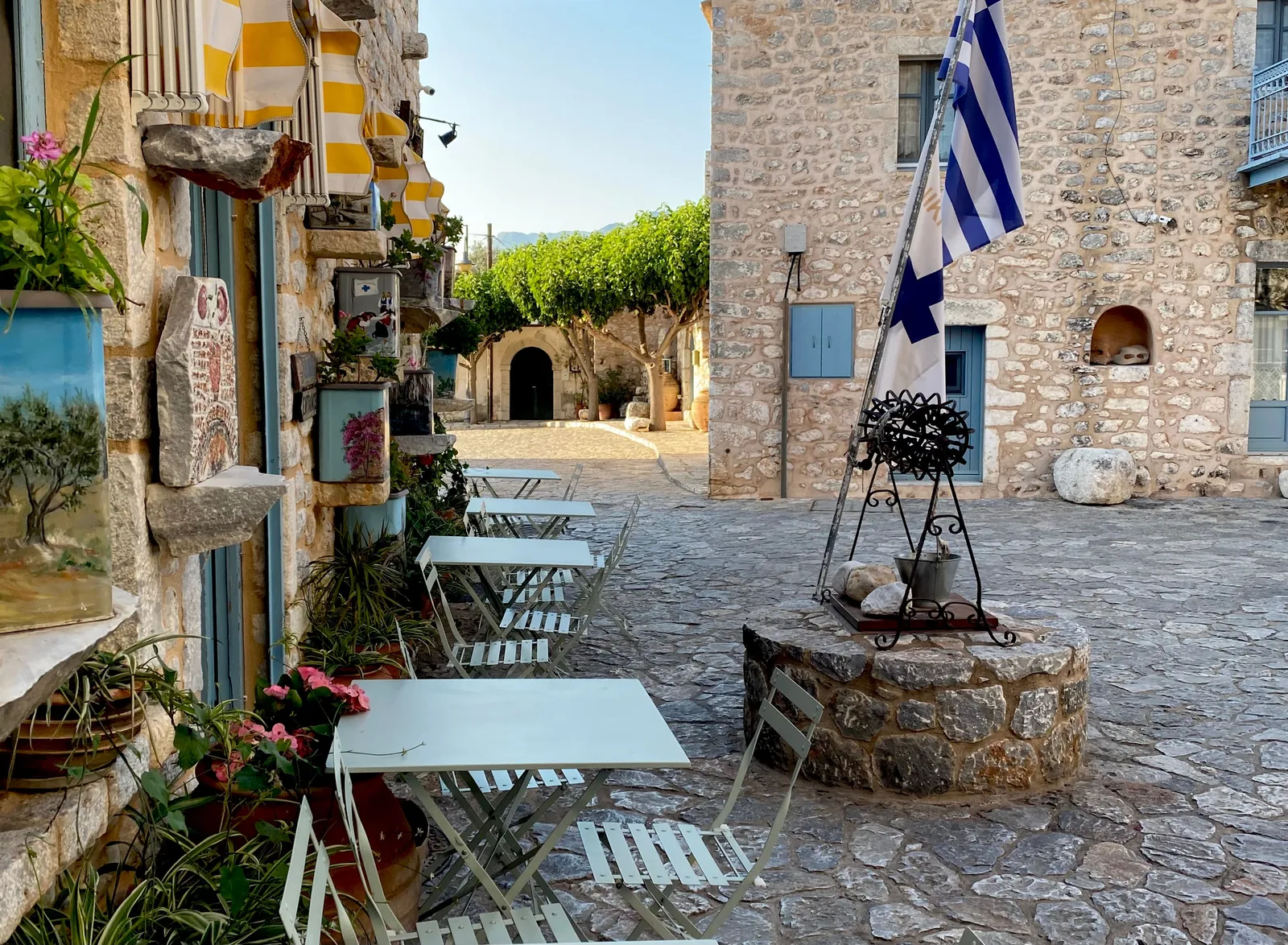 Marble-paved lane in Nafplio old town with neoclassical houses and cafe tables, Peloponnese, Greece