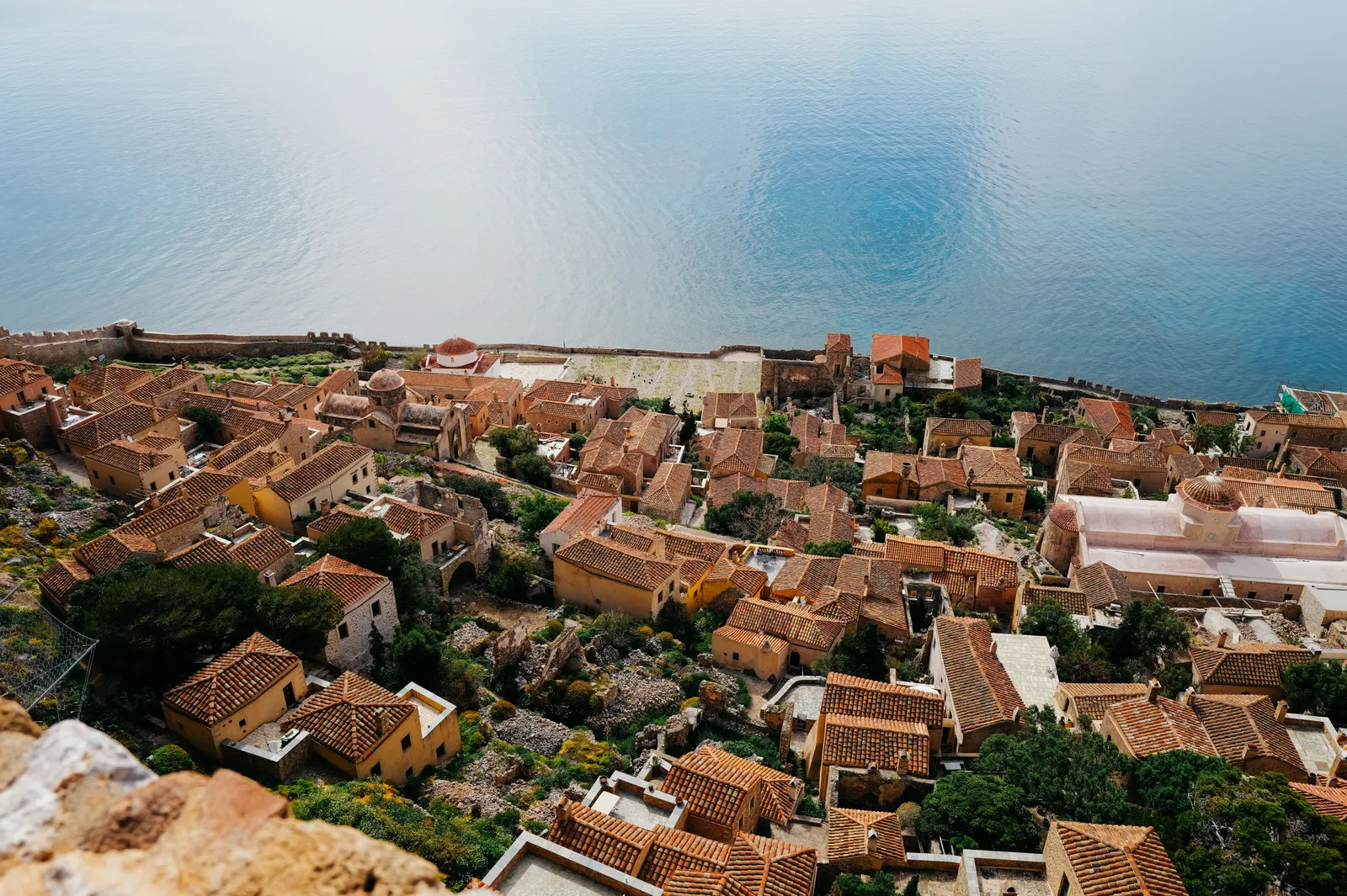 Stone houses and a church on a headland surrounded by sea in the southern Peloponnese