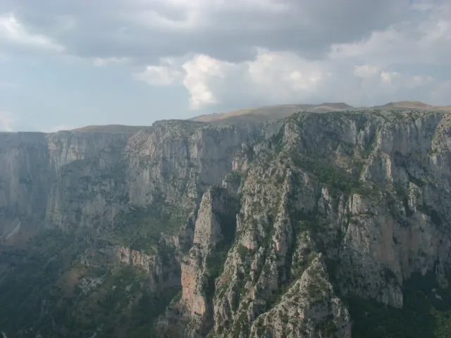 A deep gorge with sheer stone walls and forested slopes
