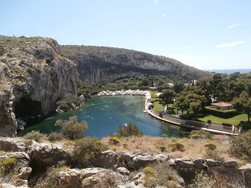 A green tinted lake enclosed by high rock cliffs