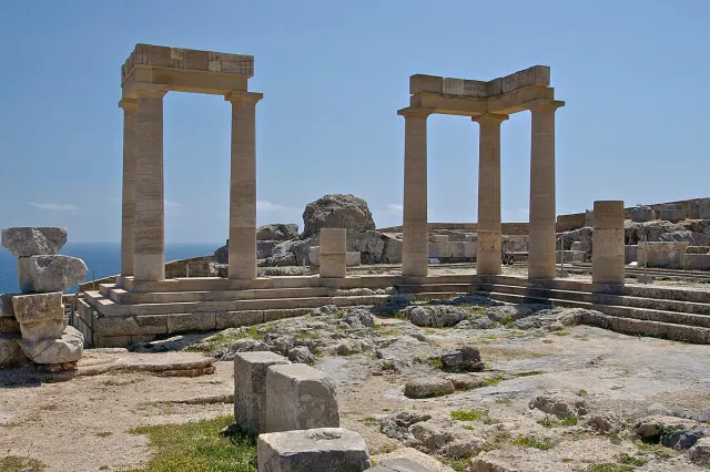 Stone columns of an ancient temple on a clifftop, with step remains around them