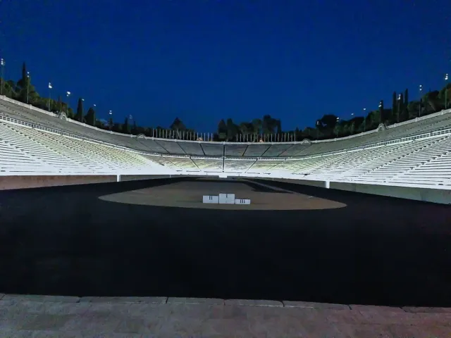 A white marble stadium with horseshoe shaped rows of seats