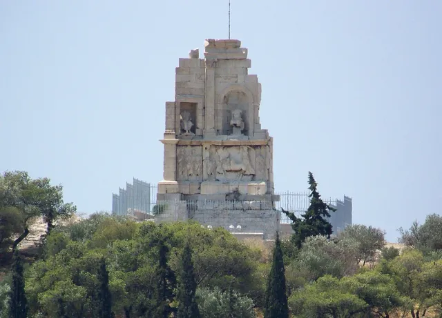 An ancient stone monument on the summit of a pine covered hill