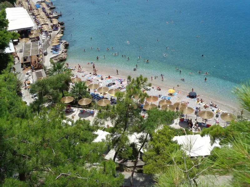 A view from above of Arvanitia beach in Nafplio, with bathers in the shallows