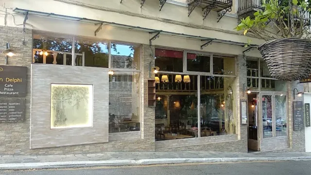 A street frontage with large windows, stone cladding, an awning and a hanging wicker lamp