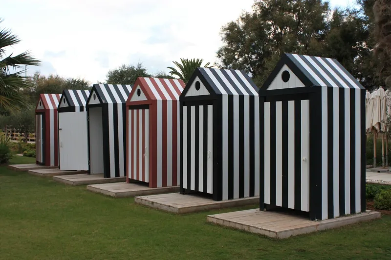 The striped beach huts on the lawn at Astir beach in Vouliagmeni
