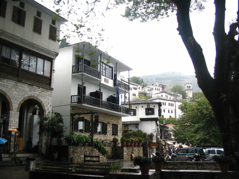 Whitewashed stone houses with wooden balconies stepping down a hillside
