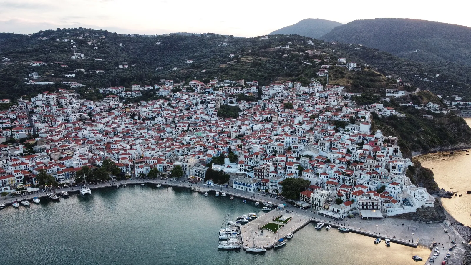 The harbour of Skopelos town with white houses climbing the hillside above the water